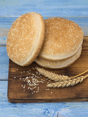 bread for hot dogs on a kitchen table. 