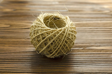 tangle of twine on brown wooden background
