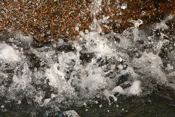 Base of Brown Stone Fountain with Water Splattering in Closeup