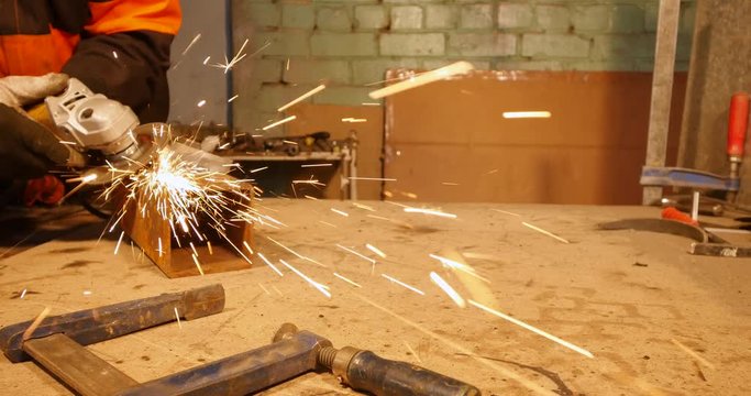 4K - Metalworking. Sparks fly to the camera