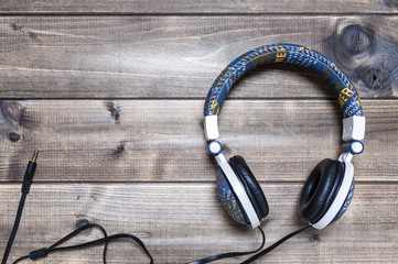 Headphone with jeans jacket on an antique wooden table