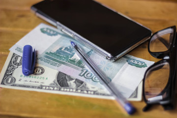 Business still life, money, pen and smartphone, glasses