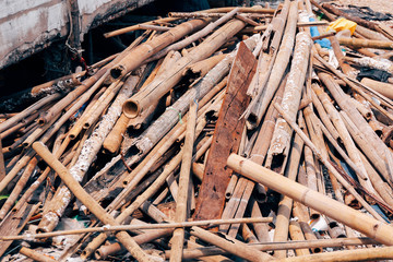 Many heap waste woods piled up in industrial construction site.