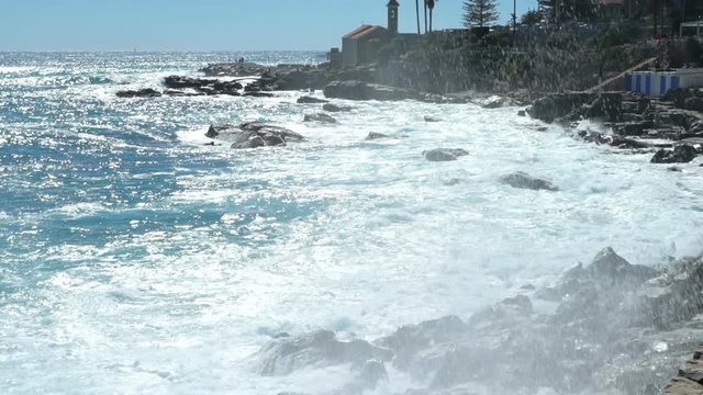 Huge waves break on the coastal cliffs of the Italian Riviera. Slow motion.