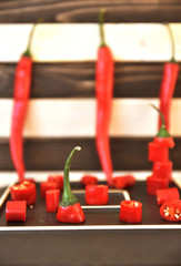 Red chili peppers on the plate close-up. Art soft focus.