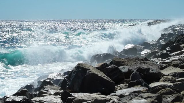 Huge waves break on the coastal cliffs of the Italian Riviera. Slow motion.