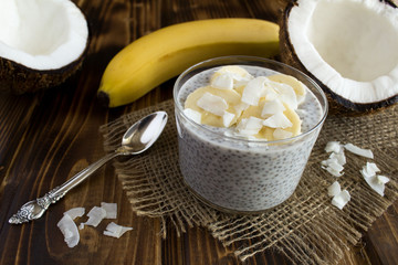 Pudding with coconut  milk,chia and banana on the rustic wooden background