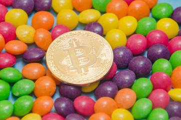 cryptocurrency gold bitcoin lies on candy, caramel.