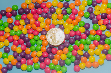 Fototapeta na wymiar cryptocurrency gold bitcoin lies on candy, caramel.
