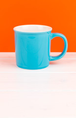blue mug with orange background