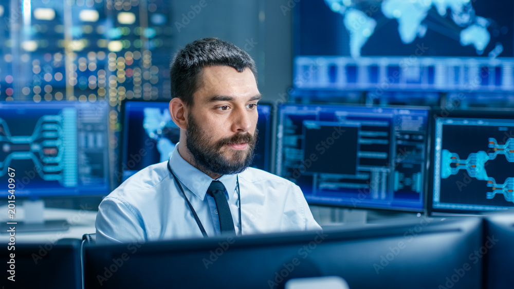 Aufkleber In the System Control Center Operator Working Surrounded by Displays Showing Relevant Data. In the Background Data with Interactive Map.