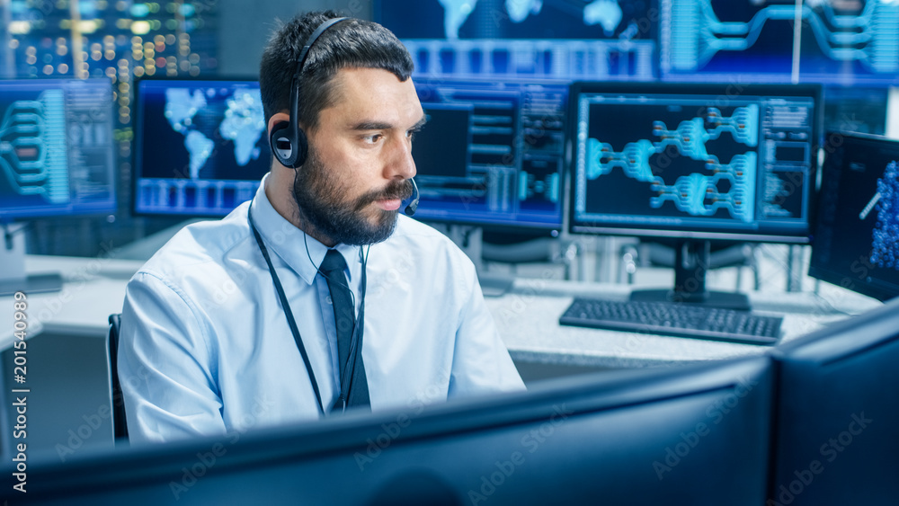 Poster In the System Monitoring Room Dispatcher Wearing Headset Observers Proper Functioning of the Facility. He's Surrounded by Screen Showing Technical Data.