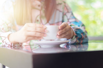 Woman drinking coffee at coffee shop