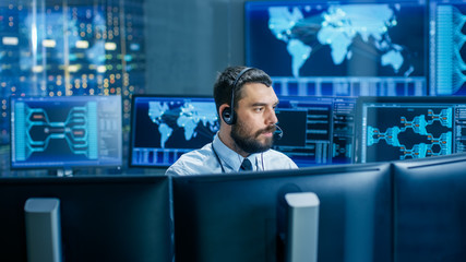 System Control Room Dispatcher Talks into Headset. He Controls Correct Work of the Facility. In the...