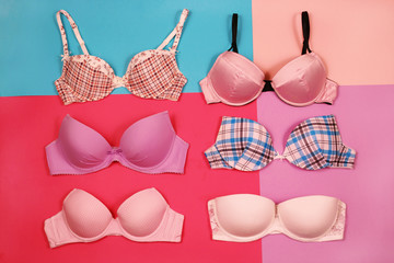 Set of different bras on multicolored background

