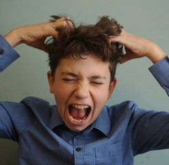 teenager boy scratching head itch because of lice close up photo