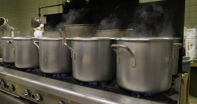 Pots Boiling Pierogies In An Industrial Kitchen Or Cafeteria.	 	