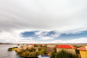 Fototapeta na wymiar Dozens of totora huts on one of the Uros islands on Lake Titicaca near Puno (Peru)