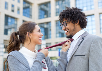 Beautiful young business couple fooling around