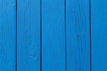 Naklejka premium The wall of the house is made of blue boards. Close-up. Background. Texture.
