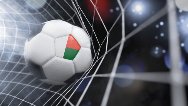 Realistic soccer ball in the net with the flag of Madagascar.(series)