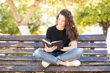 Woman reading an interesting book in park