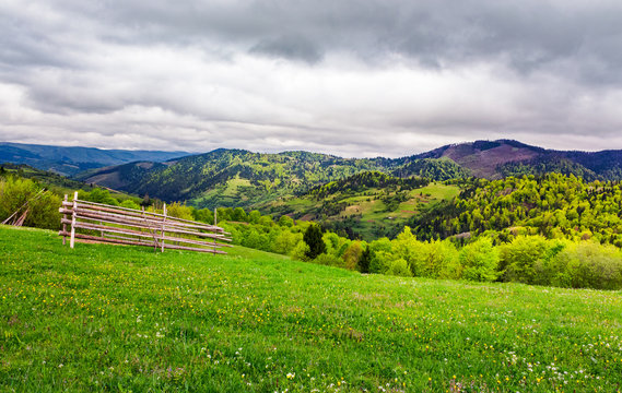 lovely rural scenery of Carpathians. beautiful landscape with grassy rural fields on hills in springtime. overcast sky over the mountains