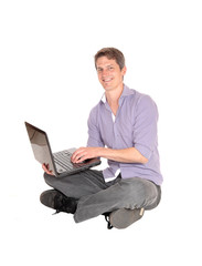 Man working on laptop on the floor