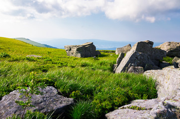 beautiful morning scenery in mountains. rocks among the grass. cloudy sky over the mountain ridge
