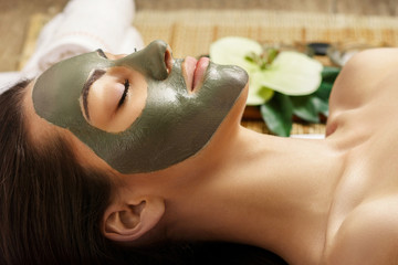 Spa Clay Mask. Woman with clay facial mask in beauty spa. Skin