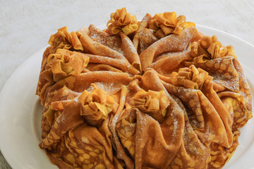 Cake of thin pancakes with cheese flavor on gray background