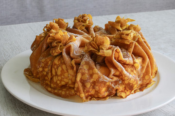 Cake of thin pancakes with cheese flavor on gray background