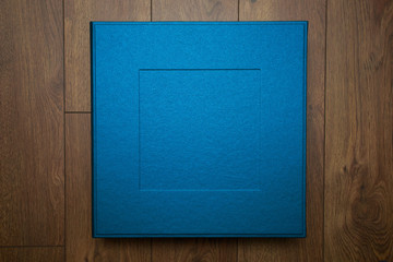 stylish designer box for photo books on a wooden background
cardboard box for a photo album 
Blue  gift box with lid. Box for wedding album.
