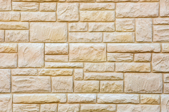 Background of natural brown stone tiles, marble brick wall