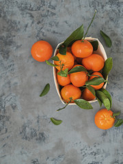 Fototapeta na wymiar Fresh tangerines with leaves