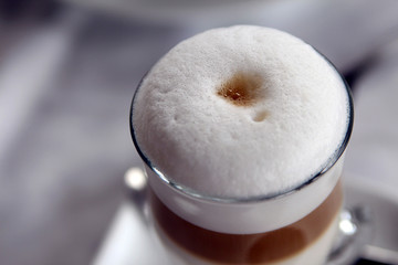 A cup of coffee drink with white lush foam