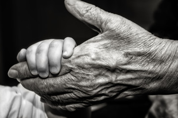 Childs hand and old wrinkled skin palm finger - 201551910