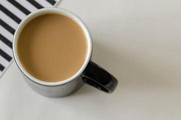 Coffee cup top view, black and white striped background, black cup,