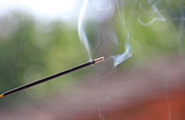 Incense stick and smoke from incense burning. Beautiful smoke. Blurred background and design with...
