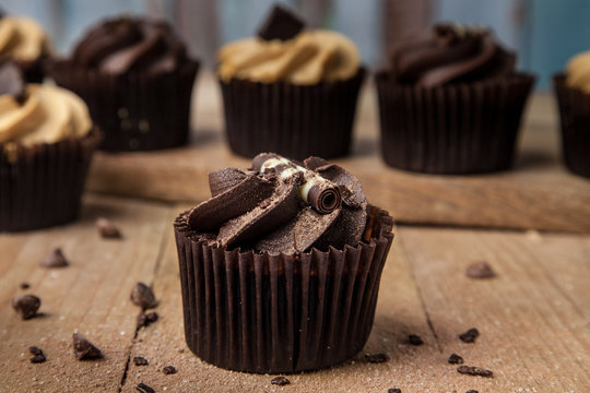 Hero chocolate cupcake on wooden table with chocolate chip