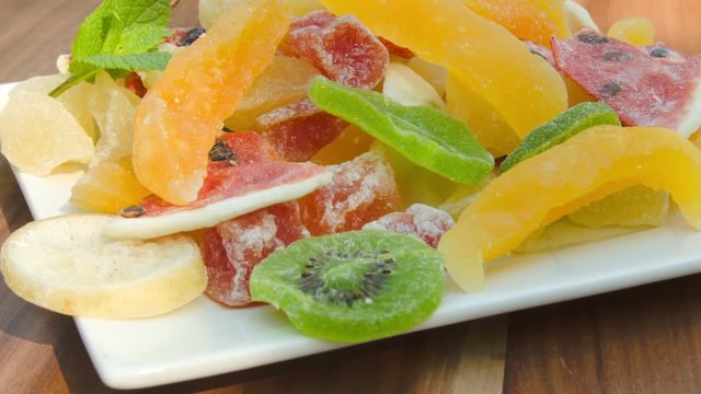 Plate of nuts and candied fruit kiwi, orange, watermelon, mango and pineapple