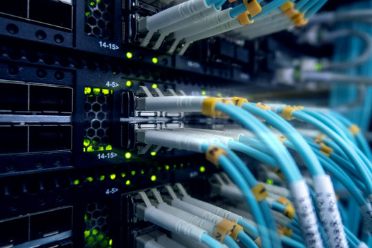 Close up fiber optic cable. Servers racks.  - Powered by Adobe