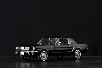 Toy model car on a black background.