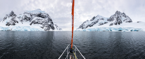 Panoramic view of sailboat bow in Lemaire Channel in Antarctica