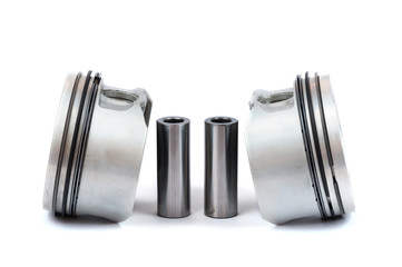 Close-up of spare parts two new pistons with connecting rods for a gasoline engine with installed sets of piston rings on an isolated white background