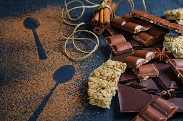 Dark and milk chocolate pieces crushed and cocoa powder, culinary background, top view