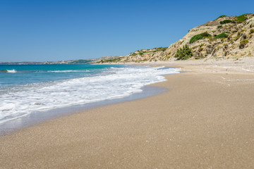 Relaxing at the greek mediterranean sea and feeling the smooth life of greece behind a green plant wall at a golden sandy robinson crusoe beach, Southcoast, Kos Island, Dodecanese, Greece