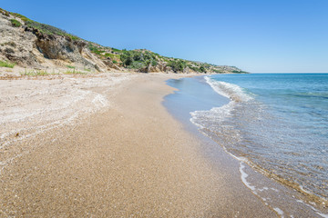 Relaxing at the greek mediterranean sea and feeling the smooth life of greece behind a green plant...