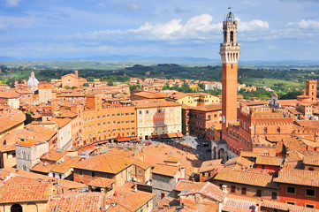 Fototapeta na wymiar City view of Siena, Tuscany, Italy, with bell tower and square: Torre del Mangia and Piazza del Campo.