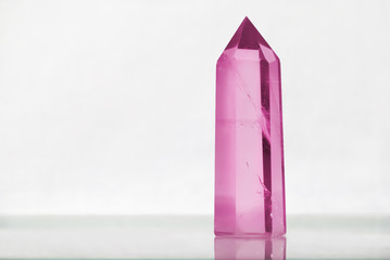 Large clear great royal crystal of quartz chalcedony on white background close up with a lilac pink shade of color